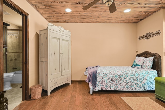 bedroom featuring wooden ceiling, hardwood / wood-style flooring, ensuite bathroom, and ceiling fan