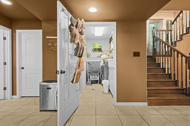 interior space featuring separate washer and dryer and light tile patterned floors