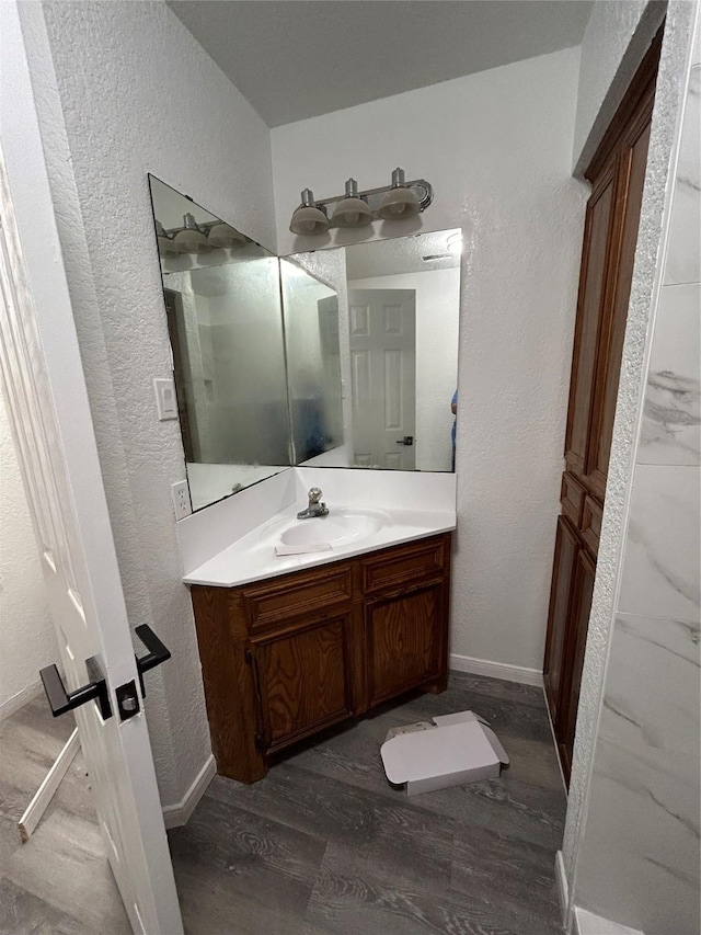 bathroom with vanity and hardwood / wood-style floors