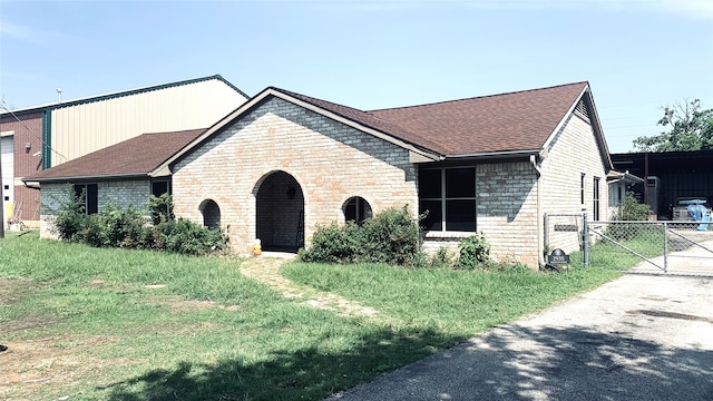 view of front of property with a front yard and a carport