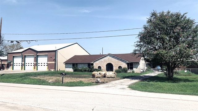 view of front facade with a garage and a front lawn