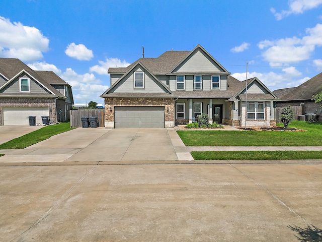 craftsman-style home with a front lawn and a garage