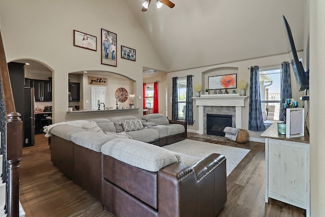 living room featuring dark hardwood / wood-style flooring, high vaulted ceiling, a wealth of natural light, and ceiling fan