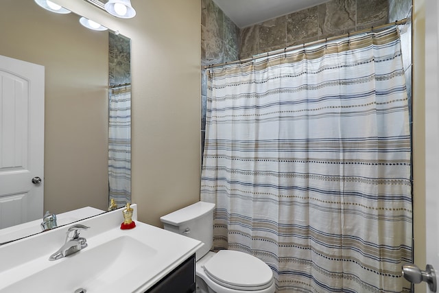 bathroom with vanity, toilet, and curtained shower