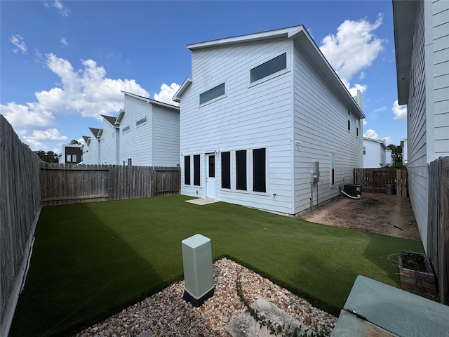 back of house featuring central air condition unit, a yard, and a patio area