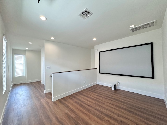 home theater with dark hardwood / wood-style flooring