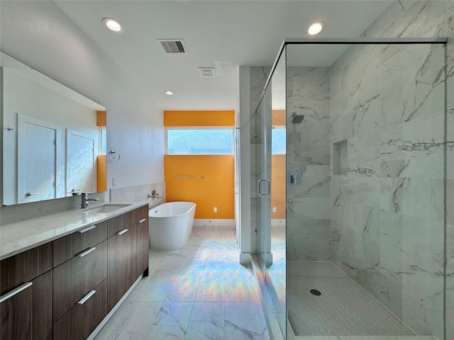 bathroom featuring vanity and separate shower and tub