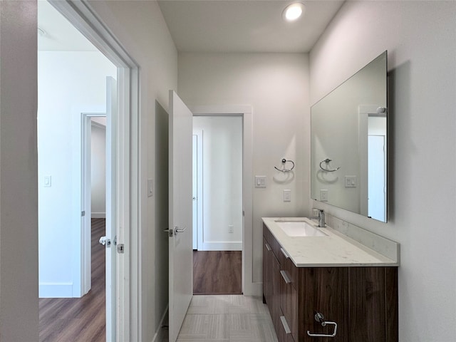 bathroom with vanity and wood-type flooring