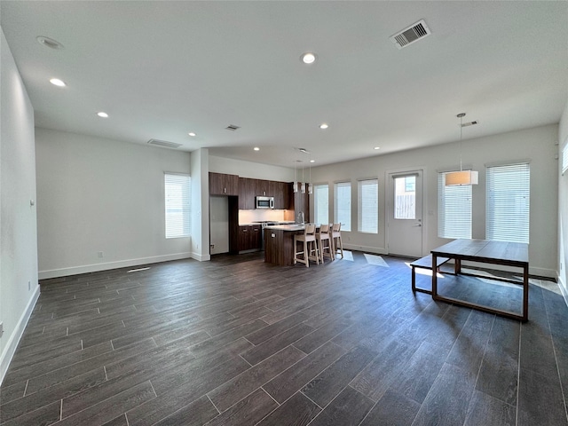 unfurnished living room featuring dark hardwood / wood-style flooring