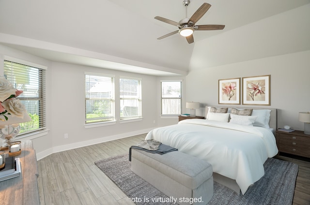 bedroom with light wood-type flooring, ceiling fan, and lofted ceiling