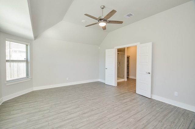 spare room with ceiling fan, light hardwood / wood-style floors, and vaulted ceiling