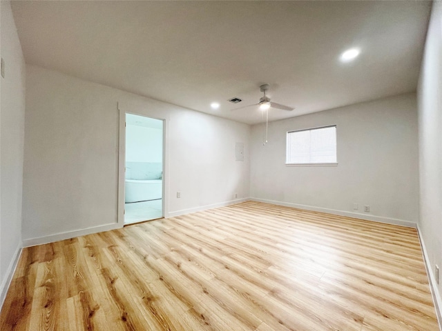 empty room with visible vents, baseboards, light wood-type flooring, and a ceiling fan