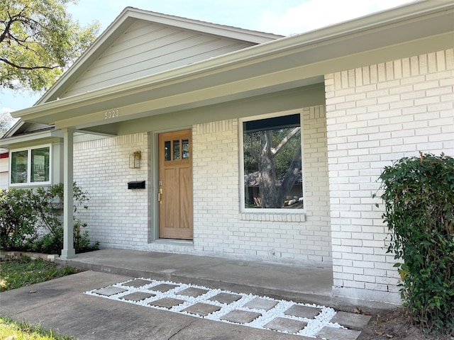 entrance to property with brick siding