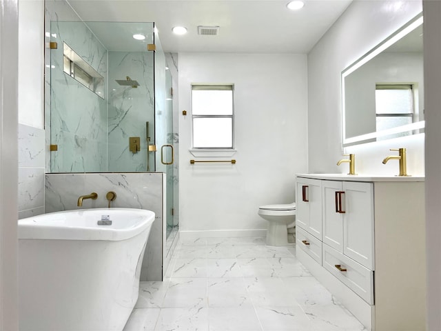 bathroom with a marble finish shower, a freestanding bath, toilet, recessed lighting, and marble finish floor