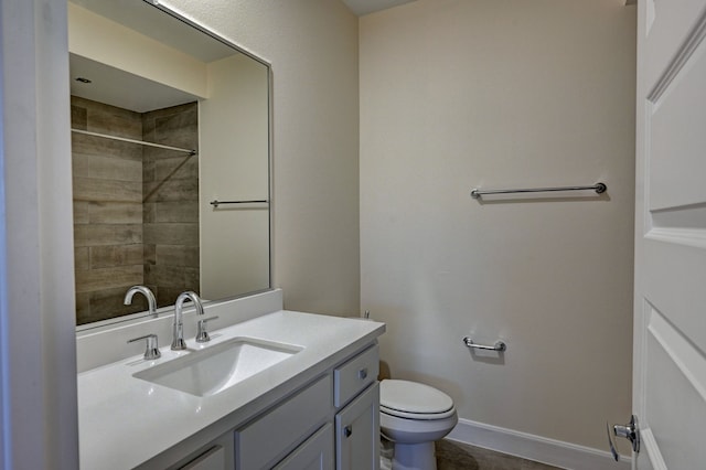 bathroom featuring tile patterned flooring, vanity, and toilet