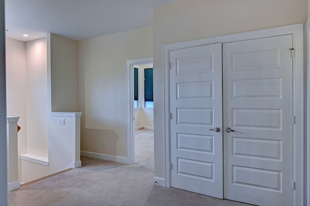 interior space featuring light carpet