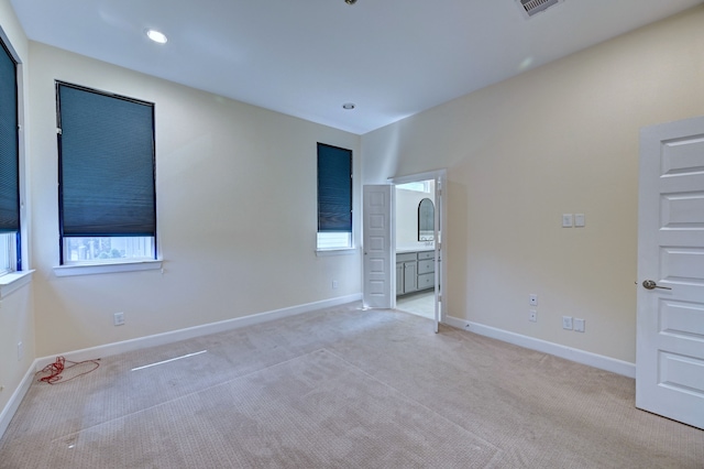 carpeted spare room featuring plenty of natural light