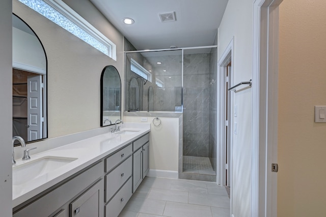 bathroom with tile patterned flooring, vanity, and an enclosed shower