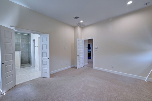 unfurnished bedroom featuring light carpet