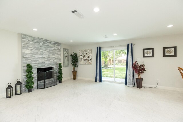 living room featuring a tiled fireplace