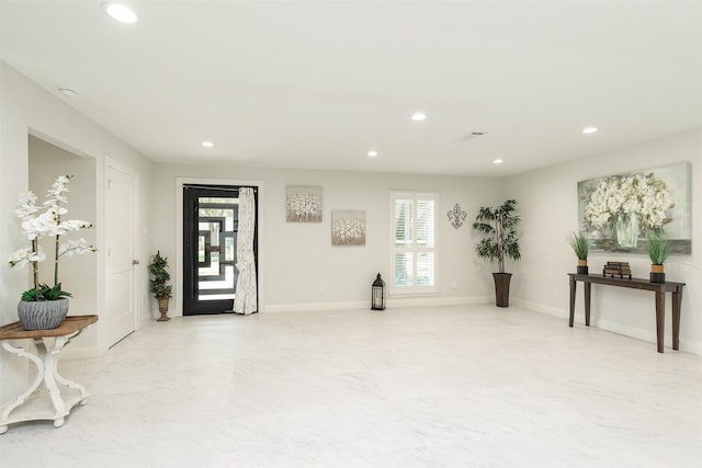 interior space with recessed lighting, a healthy amount of sunlight, marble finish floor, and baseboards