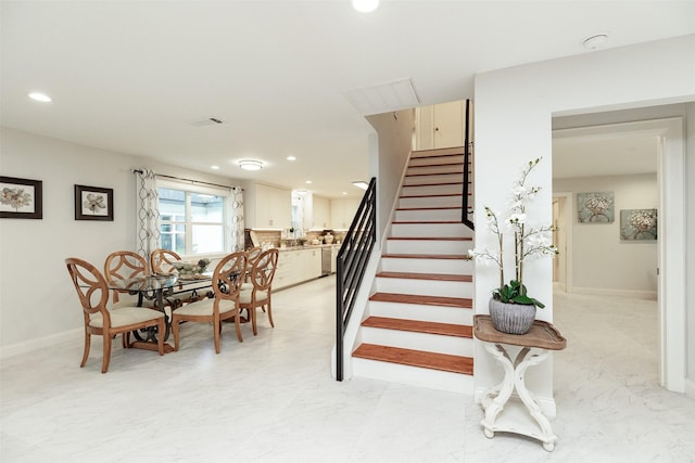 stairway featuring recessed lighting, visible vents, baseboards, and marble finish floor