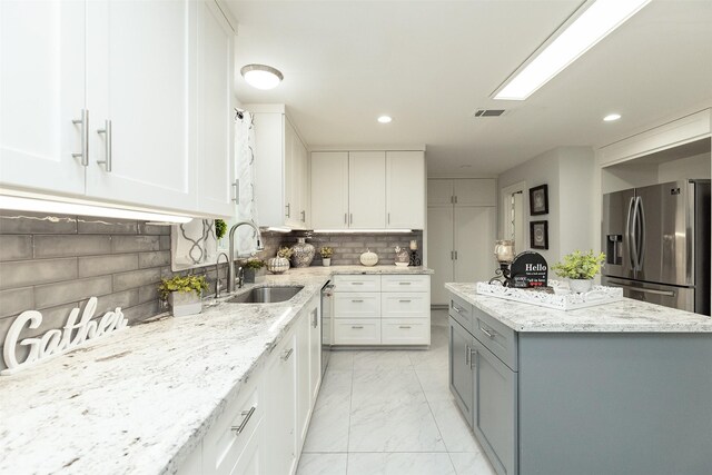 kitchen featuring stainless steel appliances, sink, and white cabinets