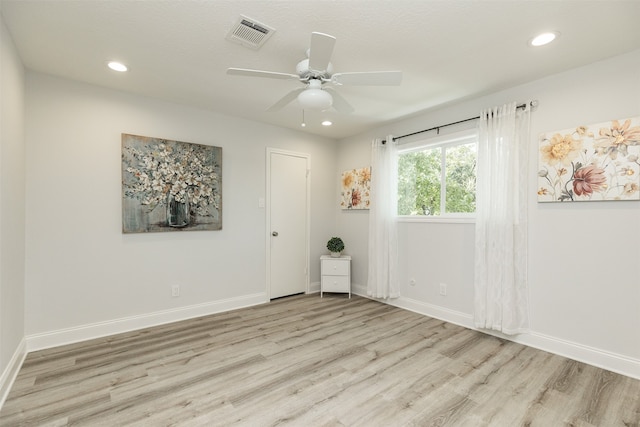 spare room with ceiling fan and light hardwood / wood-style floors