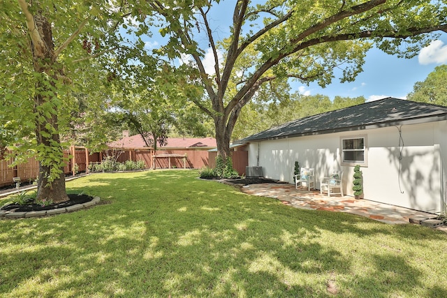 view of yard featuring central air condition unit and a patio area