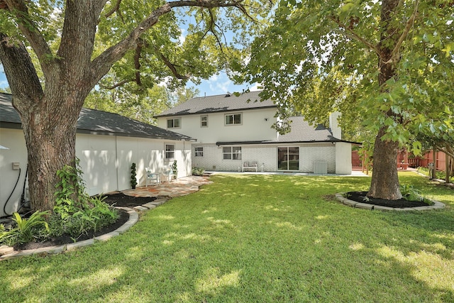 back of house with a yard, cooling unit, and a patio