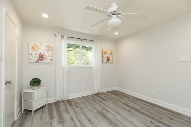 unfurnished room with ceiling fan and light hardwood / wood-style floors