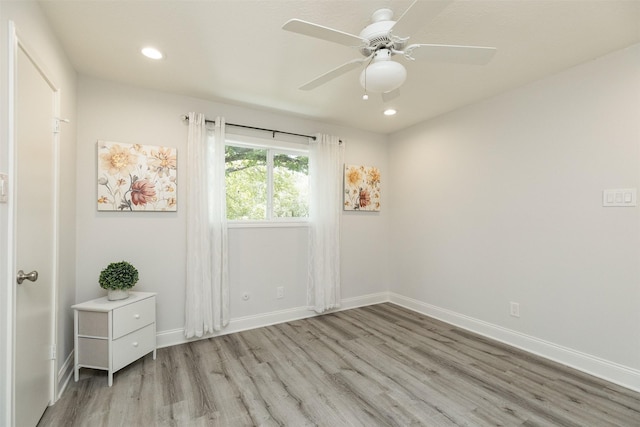 spare room with recessed lighting, baseboards, light wood-style floors, and a ceiling fan