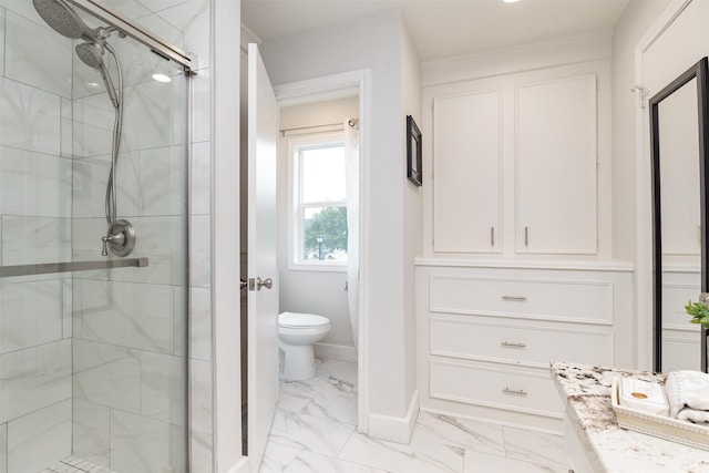 full bathroom featuring marble finish floor, toilet, a shower stall, and baseboards