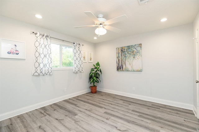 unfurnished room featuring baseboards, ceiling fan, and wood finished floors