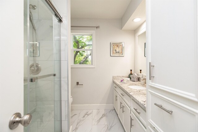 bathroom with toilet, a shower with door, and vanity