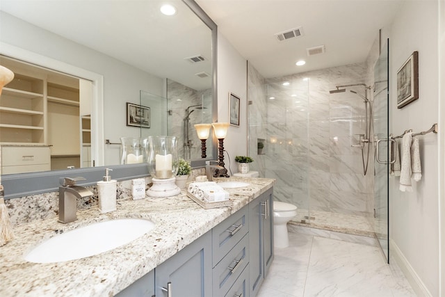 full bathroom featuring a marble finish shower, visible vents, and a sink