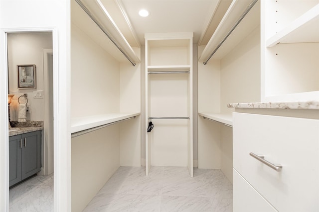 spacious closet featuring marble finish floor