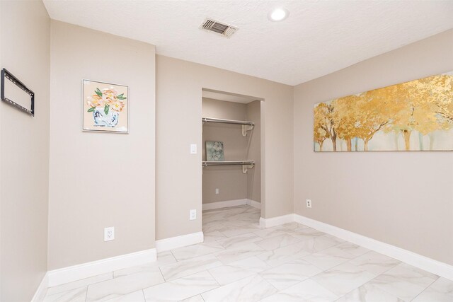 spare room featuring a textured ceiling