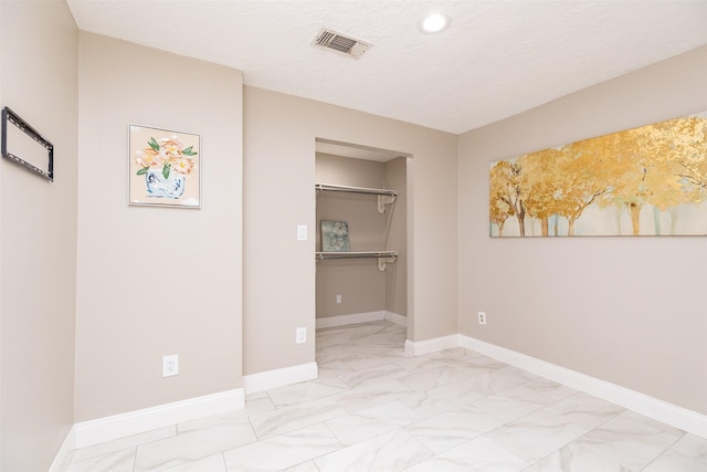 unfurnished bedroom with baseboards, visible vents, and marble finish floor