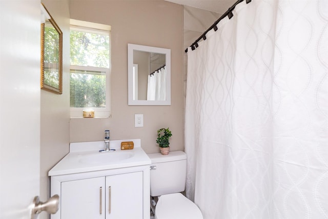 full bath with a shower with shower curtain, toilet, and vanity