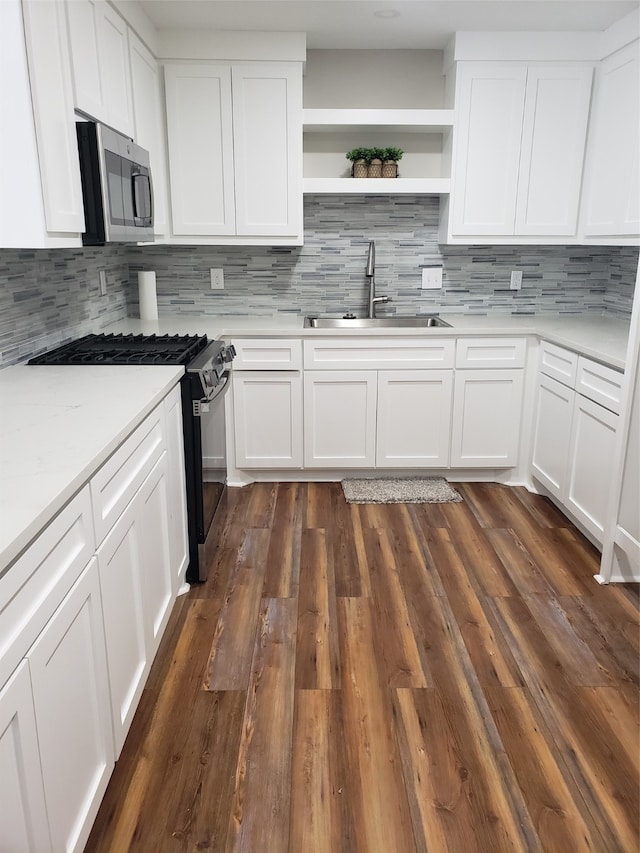 kitchen featuring white cabinets, appliances with stainless steel finishes, and sink