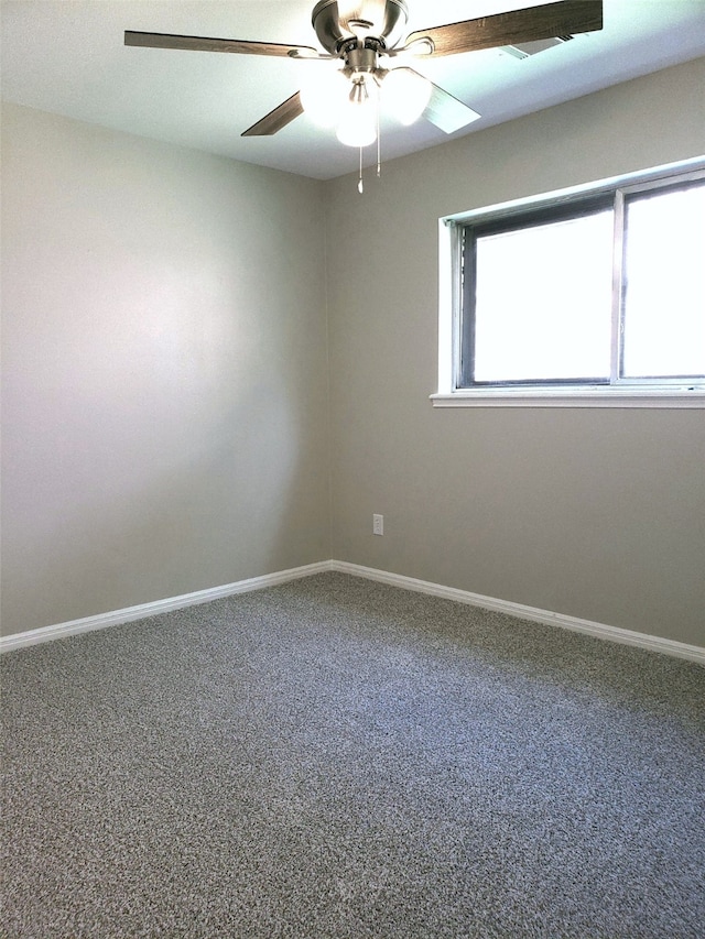 spare room featuring ceiling fan and carpet floors