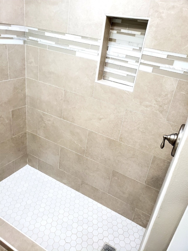 bathroom with tiled shower