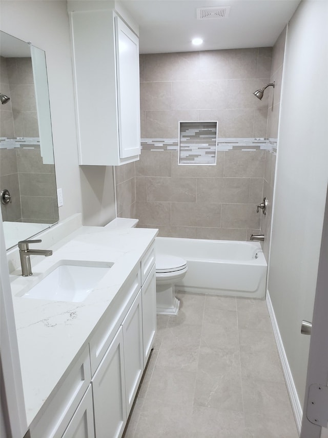 full bathroom featuring vanity, toilet, and tiled shower / bath