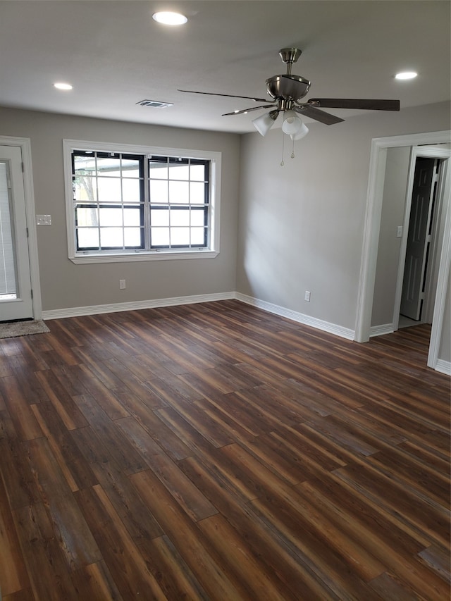 spare room featuring ceiling fan and dark hardwood / wood-style flooring