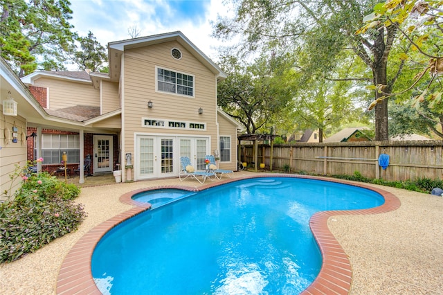 view of swimming pool featuring a patio and french doors