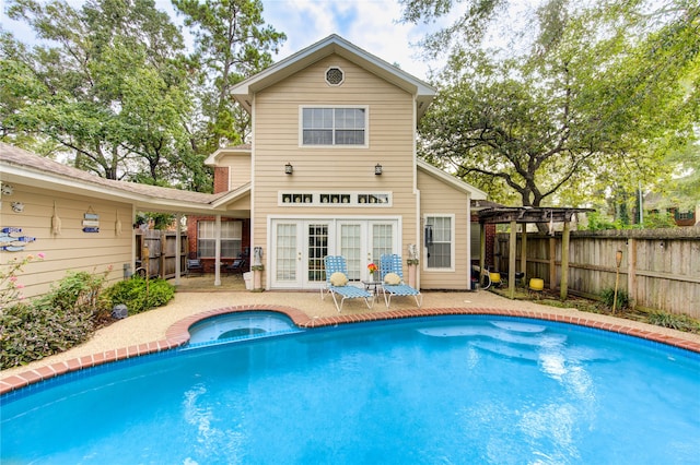 view of swimming pool featuring french doors and a patio area