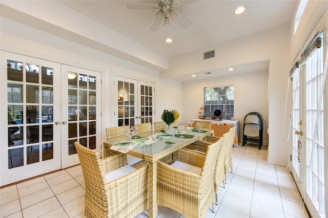 tiled dining room featuring ceiling fan and french doors