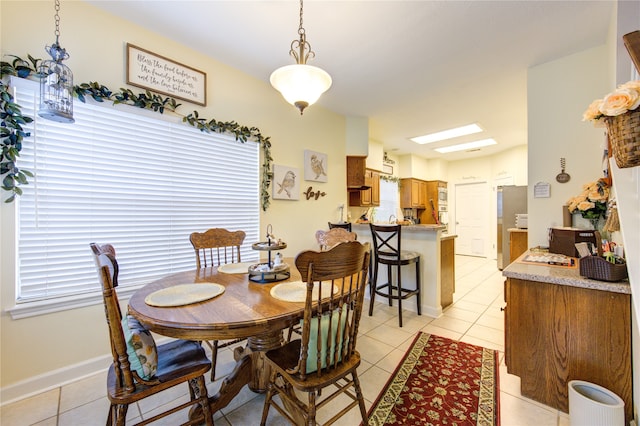 dining space with light tile patterned floors and a wealth of natural light