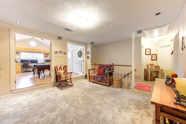 game room featuring a textured ceiling, lofted ceiling, and carpet flooring